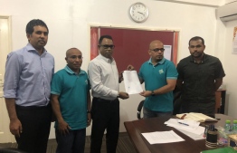 Elections Commission's President Ahmed Shareef (R-2) presents authorisation document to PNC's Chair Abdul Raheem Abdulla. PHOTO/ABDUL RAHEEM ABDULLA