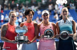 Australia's Samantha Stosur (L) and China's Zhang Shuai (2nd L) celebrate with the championship trophy after winning the women's doubles final against Hungary's Timea Babos (2nd R) and France's Kristina Mladenovic (R) on day 12 of the Australian Open tennis tournament in Melbourne on January 25, 2019. (Photo by Saeed KHAN / AFP) / 