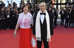 (FILES) In this file photo taken on May 17, 2017 French music composer Michel Legrand and his wife French actress Macha Meril pose as they arrive for the screening of the film 'Ismael's Ghosts' (Les Fantomes d'Ismael) during the opening ceremony of the 70th edition of the Cannes Film Festival in Cannes, southern France. - Legrand died aged 86, AFP reported on January 26, 2019. (Photo by Alberto PIZZOLI / AFP)