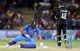 India's Rohit Sharma (L) is stumped by New Zealand's Tom Latham (R) during the third one-day international cricket match between New Zealand and India at Bay Oval in Mount Maunganui on January 28, 2019. (Photo by MICHAEL BRADLEY / AFP)