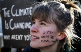 A student takes part in a "school strike for climate" held on the sidelines of the World Economic Forum (WEF) annual meeting, on January 25, 2019 in Davos, eastern Switzerland. - Swedish 16-year-old Greta Thunberg has inspired a wave of climate protests by schoolchildren around the world after delivering a fiery speech at the UN climate summit in Katowice, Poland last month. (Photo by Fabrice COFFRINI / AFP)