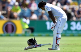 Sri Lanka's batsman Kusal Perera retires hurt after being hit by a ball from Australia's paceman Jhye Richardson during day three of the second Test cricket match between Australia and Sri Lanka at the Manuka Oval Cricket Ground in Canberra on February 3, 2019. (Photo by Saeed KHAN / AFP) / -- IMAGE RESTRICTED TO EDITORIAL USE - STRICTLY NO COMMERCIAL USE --