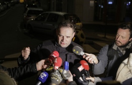 Fire service spokesman Clement Cognon speaks to the press after a building caught fire in the 16th arrondissement in Paris, on February 5, 2019. - Seven people died and another was seriously injured in a building fire in a wealthy Paris neighbourhood on Monday night, the fire service said. The blaze in the French capital's trendy 16th arrondissement also left 27 people -- including three firefighters -- with minor injuries. (Photo by GEOFFROY VAN DER HASSELT / AFP)