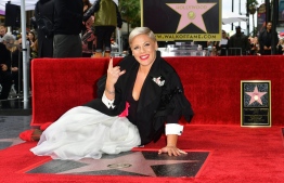 Recording artist Pink poses on her Hollywood Walk of Fame Star at a ceremony in Hollywood, California, on February 5, 2019. (Photo by Frederic J. BROWN / AFP)