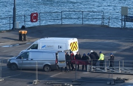 A body is taken off the Geo Ocean III, recovered from the wreckage of a plane carrying Argentine footballer Emiliano Sala at Weymouth harbour, south west England on February 7, 2019. - A body recovered by British investigators from the submerged wreckage of a plane that went down in the Channel has been identified as that of footballer Emiliano Sala, police said on February 7, 2019. The Argentine striker's body was first spotted by rescuers with a remotely operated vehicle (ROV) on Sunday close to where the plane went missing near the British island of Guernsey. (Photo by Glyn KIRK / AFP)