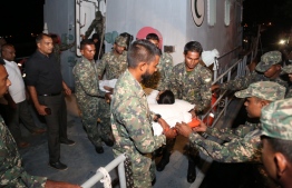 Dengue patient from Feeali, Faafu Atoll being brought aboard sea ambulance for transportation to the capital for treatment  PHOTO: MALDIVES NATIONAL DEFENCE FORCE (MNDF)