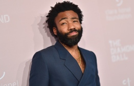 (FILES) In this file photo taken on September 13, 2018 Childish Gambino/Donald Glover attends Rihanna's 4th Annual Diamond Ball at Cipriani Wall Street in New York City. - For many artists, the Grammy awards gala is not just music's biggest night -- it is also a cultural battleground rife with criticisms that provocative black artists are systematically not getting their due. This year, that criticism could be muted -- even if momentarily -- when the Best Music Video prize is handed out. The five nominees in the oft-overlooked category are boundary-pushing -- and they are all black. Their visual work showcases industry innovation and is rich with social commentary on Donald Trump's America. "It's the year of Trump -- the need to speak out is overwhelming," Carol Vernallis, a music scholar at Stanford University in California, told AFP. "I can imagine African-American artists feeling the need to push."Childish Gambino -- the favorite to win on February 10, 2019, according to award prediction website Gold Derby -- took the internet by storm last spring with his painfully striking viral video, "This Is America." (Photo by Angela Weiss / AFP)
