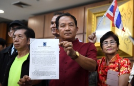 Srisuwan Janya, secretary-general of the Association for the Protection of the Constitution submits a petition to the election commission to investigate the Thai Raksa Chart party for nominating Princess Ubolratana as its candidate for prime minister in Bangkok on February 11, 2019. - The Thai Raksa Chart party, affiliated with the powerful Shinawatra political clan, had announced the princess as their candidate on February 8 -- a move which rattled the status quo and threatened the ambitions of the generals in power. (Photo by Lillian SUWANRUMPHA / AFP)