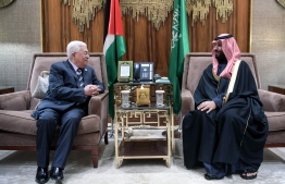 A handout picture provided by the Palestinian Authority's press office (PPO) on February 12, 2019 shows Palestinian president Mahmoud Abbas (L) meeting with Saudi Arabia's Crown Prince Mohammed bin Salman in the Saudi capital Riyadh. (Photo by - / PPO / AFP) / 