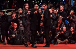 Israeli director Nadav Lapid (C) poses with the Golden bear for best film for “Synonymes“ and French actress Louise Chevillotte and actor Tom Mercier on the red carpet after the awards ceremony of the 69th Berlinale film festival on February 16, 2019 in Berlin.