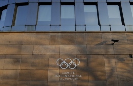 A picture taken in Lausanne, on February 15, 2019 shows the olympics logo on the IOC Headquarters building. (Photo by SALVATORE DI NOLFI / POOL / AFP)