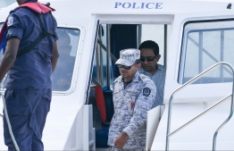 Former President Abdulla Yameen Abdul Gayoom being escorted to the capital by a member of Maldives Correctional Service. PHOTO: HUSSAIN WAHEED/ MIHAARU