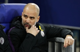 Manchester City's Spanish coach Josep Guardiola waits before the UEFA Champions League round of 16 first leg football match between Schalke 04 and Manchester City  on February 20, 2019 in Gelsenkirchen, Germany. (Photo by Odd ANDERSEN / AFP)