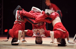 (FILES) In this file photo taken on November 21, 2010 members of Mortal Kombat crew from Japan perform during the first part of the "Battle of the Year", an international competition of breakdance (Boty), at Arena in Montpellier. - Breakdancing, skateboarding, climbing and surfing have been invited to join the 2024 Paris Olympics, the head of the local organising committee said on February 21, 2019. Tony Estanguet said the inclusion of the sports responded to a need to make the Olympics "more urban" and "more artistic". (Photo by Anne-Christine POUJOULAT / AFP)