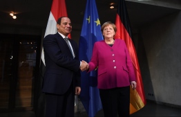 German Chancellor Angela Merkel (R) shakes hands with Egypt's President Abdel Fattah el-Sisi at the 55th Munich Security Conference in Munich, southern Germany, on February 16, 2019. - The 2019 edition of the Munich Security Conference (MSC) takes place from February 15 to 17, 2019. (Photo by Christof STACHE / AFP)