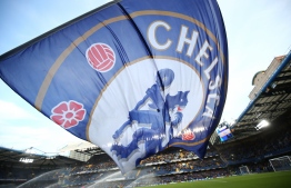(FILES) In this file photo taken on January 16, 2016 A giant Chelsea flag flies before kick off of the English Premier League football match between Chelsea and Everton at Stamford Bridge in London on January 16, 2016. - Premier League club Chelsea have been banned from signing new players in the next two transfer windows as punishment for breaking rules on registering under-age players, FIFA said on February 22, 2019. (Photo by Justin TALLIS / AFP) / RESTRICTED TO EDITORIAL USE. No use with unauthorized audio, video, data, fixture lists, club/league logos or 'live' services. Online in-match use limited to 75 images, no video emulation. No use in betting, games or single club/league/player publications. / 