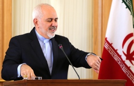 This picture taken on February 13, 2019 shows Iran's Foreign Minister Mohammad Javad Zarif checks his watch during a press conference in Tehran. - Zarif, who was the lead negotiator in the 2015 nuclear deal, announced his resignation on Instagram on February 25, 2019. "I apologise for my inability to continue serving and for all the shortcomings during my term in office," Zarif said in message posted on his verified Instagram account. (Photo by ATTA KENARE / AFP)