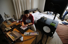 Sarouna, a Palestinian DJ, works on a music track at her home in the West Bank city of Ramallah, in the Israeli-occupied West Bank, on February 7, 2019. - "Electrosteen" is a collaborative work between artists from the Palestinian territories, Israel, Britain, France and Jordan. Each with their own musical backgrounds, the artists worked from hundreds of pieces of traditional Palestinian music recorded about 15 years ago by the Popular Art Centre. (Photo by ABBAS MOMANI / AFP)