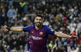 Barcelona's Uruguayan forward Luis Suarez celebrates his second goal during the Spanish Copa del Rey (King's Cup) semi-final second leg football match between Real Madrid and Barcelona at the Santiago Bernabeu stadium in Madrid on February 27, 2019. (Photo by JAVIER SORIANO / AFP)