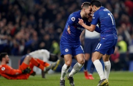 Chelsea's Spanish midfielder Pedro (R) celebrates scoring the opening goal with Chelsea's Belgian midfielder Eden Hazard during the English Premier League football match between Chelsea and Tottenham Hotspur at Stamford Bridge in London on February 27, 2019. (Photo by Adrian DENNIS / AFP)