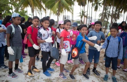 Students of Baa Atoll Education Centre participating in a beach clean-up. PHOTO: JAMES APPLETON PHOTOGRAPHY/ STAND UP FOR OUR SEAS