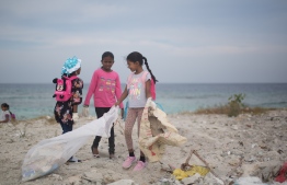 Students participating in a clean-up of Eydhafushi beach. PHOTO: JAMES APPLETON PHOTOGRAPHY/ STAND UP FOR OUR SEAS