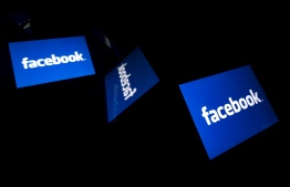 (FILES) This illustration file picture shows the US social media Facebook logo displayed on a tablet in Paris on February 17, 2019. Facebook said on September 19, 2019 it will let advertisers pack more fun into marketing messages with augmented reality, games and playful polls to prompt interactions. People using the leading social network or its Instagram or Messenger services could be enticed with ads that ask for opinions, invite game moves, or tap into camera capabilities to provide a virtual glimpse at how they might look wearing certain lipstick.