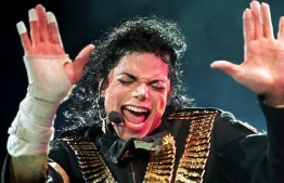 (FILES) In this file photo taken on August 31, 1993, US pop megastar Michael Jackson performs during his "Dangerous" tour in Singapore. - An unflinching new documentary on pedophilia accusations against Michael Jackson shatters the veneer of his larger-than-life celebrity, presenting in stark, lurid detail the stories of two men who say the late King of Pop for years sexually abused them as minors. (Photo by STR / AFP)