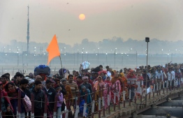 Indian Hindu devotees arrive to take a holy dip at the Sangam -- the confluence of the Ganges, Yamuna and mythical Saraswati rivers -- on the occasion of Maha Shivaratri and the last day of the Kumbh Mela festival in Allahabad on March 4, 2019. (Photo by SANJAY KANOJIA / AFP)