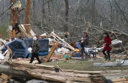 Residents look for belongings March 4, 2019 at a home after it was destroyed in a tornado in Beauregard, Alabama. - Rescuers in Alabama resumed search operations Monday after at least two tornadoes killed 23 people, uprooted trees and caused "catastrophic" damage to buildings and roads in the southern US state. "The devastation is incredible," Lee County Sheriff Jay Jones told the local CBS affiliate late Sunday."I cannot recall at least in the last 50 years... a situation where we have had this loss of life that we experienced today." (Photo by Tami Chappell / AFP)