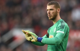 Manchester United's Spanish goalkeeper David de Gea (R) gestures during the English Premier League football match between Manchester United and Liverpool at Old Trafford in Manchester, north west England, on February 24, 2019. (Photo by Oli SCARFF / AFP) / RESTRICTED TO EDITORIAL USE. No use with unauthorized audio, video, data, fixture lists, club/league logos or 'live' services. Online in-match use limited to 120 images. An additional 40 images may be used in extra time. No video emulation. Social media in-match use limited to 120 images. An additional 40 images may be used in extra time. No use in betting publications, games or single club/league/player publications. / 