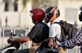Motorcyclist and passenger wearing helmets. PHOTO: AHMED NISHAATH / MIHAARU