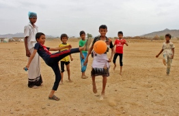 Displaced Yemeni children from the province of Hodeidah play football in a makeshift camp in the northern district of Abs in Yemen's northwestern Hajjah province, on March 06, 2019. (Photo by ESSA AHMED / AFP)