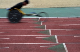 This photo taken on February 13, 2019 shows Japanese Paralympian Masayuki Higuchi during a training session at a track and field stadium in Noda, Chiba prefecture. - For Higuchi, a middle-distance athlete who competed at the 2016 Rio Paralympics, the most important aspect of the wheelchair is "stability at high speed." (Photo by Toshifumi KITAMURA / AFP) / 
