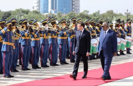 French president Emmanuel Macron (2nd R) is welcomed by Djibouti president Ismail Omar Guelleh (R) during an official military welcome ceremony at the presidential palace in Djibouti on March 12, 2019. French President Macron tours Horn of Africa nations, with stops in Djibouti, Ethiopia and Kenya.
Ludovic MARIN / POOL / AFP