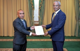 President Ibrahim Mohamed Solih presents the letter of appointment to Commission member Habeeb during a ceremony held at the President’s Office. PHOTO: PRESIDENT'S OFFICE