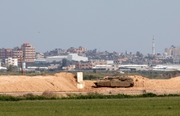 A picture taken on March 15, 2019, shows an Israeli Merkava battle tank near the border with the Gaza Strip near the Kibbutz of Nahal Oz in southern Israel. - Weekly protests along the Gaza-Israel border were called off on March 15 after a military escalation between the Jewish state and the Palestinian territory's Islamist rulers Hamas, organisers announced. The cancellation, the first of its kind in a year, came after Israel said its aircraft struck dozens of Hamas targets in Gaza overnight in response to rockets fired from the enclave, including at Tel Aviv. (Photo by JACK GUEZ / AFP)