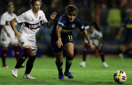 Boca Juniors' Yamila Rodriguez (R) and Lanus' midfielder Vanina Garcia Cueva, vie for the ball during a Women's League football match to commemorate the International Women's Day, at the La Bombonera stadium before the Superliga Argentina football match between Boca Juniors and San Lorenzo, in Buenos Aires, on March 9, 2019. PHOTO: ALEJANDRO PAGNI / AFP