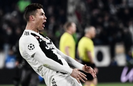 Juventus' Portuguese forward Cristiano Ronaldo celebrates after scoring 3-0 during the UEFA Champions League round of 16 second-leg football match Juventus vs Atletico Madrid on March 12, 2019 at the Juventus stadium in Turin. PHOTO: MARCO BERTORELLO / AFP