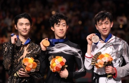 Winner Nathan Chen of the US (C), silver medallists Yuzuru Hanyu of Japan (L) and bronze medallists Vincent Zhou of the US (R) pose with their medals during the men's free skating competition of the ISU World Figure Skating Championships in Saitama on March 23, 2019. (Photo by Toshifumi KITAMURA / AFP)