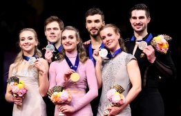 ISU World Figure Skating Championships Ice Dance winner Gabriella Papadakis and Guillaume Cizeron of France (C), silver medalists, Victoria Sinitsina and Nikita Katsalapov of Russia (L) and bronze medalists Madison Hubbell and Zachary Doohue of the US (R) pose with their medals during the victory ceremony in Saitama, northern suburb of Tokyo on March 23, 2019. (Photo by Toshifumi KITAMURA / AFP)
