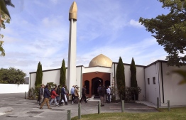 Members of the local Muslim community enter the Al Noor mosque after is was reopened in Christchurch on March 23, 2019. - Muslims returned on March 23 to Christchurch's main mosque for the first time since a white supremacist launched a massacre of 50 worshippers there, as New Zealand sought to return to normal following the searing tragedy. (Photo by WILLIAM WEST / AFP)