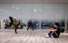 This photo taken on March 18, 2019 shows breakdancers taking part in a training session at a studio in Shanghai. - The International Olympic Committee (IOC) on March 27 gave it the provisional nod for inclusion at the Paris 2024 Games. (Photo by MATTHEW KNIGHT / AFP) / 