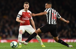 Arsenal's Welsh midfielder Aaron Ramsey (L) vies with Newcastle United's English midfielder Isaac Hayden during the English Premier League football match between Arsenal and Newcastle United at the Emirates Stadium in London on April 1, 2019. (Photo by Glyn KIRK / AFP) / RESTRICTED TO EDITORIAL USE. No use with unauthorized audio, video, data, fixture lists, club/league logos or 'live' services. Online in-match use limited to 120 images. An additional 40 images may be used in extra time. No video emulation. Social media in-match use limited to 120 images. An additional 40 images may be used in extra time. No use in betting publications, games or single club/league/player publications. / 
