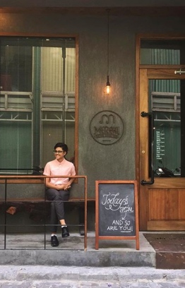 Former barista Inas Ismail sitting outside Meraki. PHOTO: MERAKI COFFEE ROASTERS