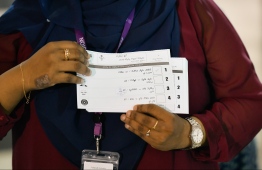 An official of Elections Commission (EC) counts ballots of the 2019 parliamentary elections. PHOTO: HUSSAIN WAHEED / MIHAARU