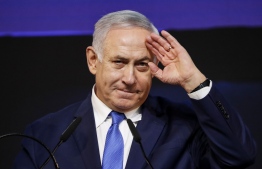 Israeli Prime Minister Benjamin Netanyahu gestures as he addresses supporters at his Likud Party headquarters in the Israeli coastal city of Tel Aviv on election night early on April 10, 2019. (Photo by Thomas COEX / AFP)