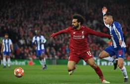Liverpool's Egyptian midfielder Mohamed Salah (C) vies with Porto's Brazilian midfielder Otavio (R) during the UEFA Champions League quarter-final, first leg football match between Liverpool and FC Porto at Anfield stadium in Liverpool, north-west England on April 9, 2019. (Photo by Paul ELLIS / AFP)