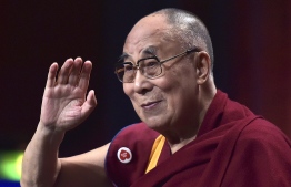 (FILES) This file photo taken on September 15, 2016 shows the spiritual leader of the Tibetan people, the Dalai Lama, gesturing as he arrives for a meeting with young people in Strasbourg. - The Dalai Lama is "doing very well" and will likely be discharged from hospital in New Delhi on April 12 as he recovers from a chest infection, his spokesman told AFP on April 11, 2019. (Photo by PATRICK HERTZOG / AFP)