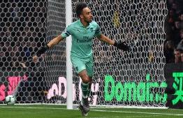 Arsenal's Gabonese striker Pierre-Emerick Aubameyang celebrates after scoring the opening goal of the English Premier League football match between Watford and Arsenal at Vicarage Road Stadium in Watford, north of London on April 15, 2019. (Photo by Ben STANSALL / AFP) / RESTRICTED TO EDITORIAL USE. No use with unauthorized audio, video, data, fixture lists, club/league logos or 'live' services. Online in-match use limited to 120 images. An additional 40 images may be used in extra time. No video emulation. Social media in-match use limited to 120 images. An additional 40 images may be used in extra time. No use in betting publications, games or single club/league/player publications. / 